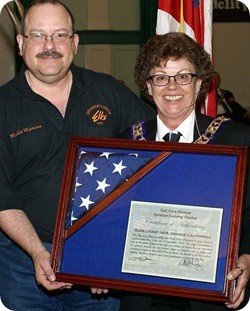 Captain Michael Merino USN presented flag flown over Guantanamo Bay