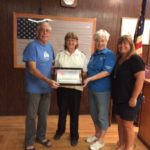 A group of people standing in front of a court room.