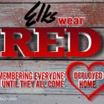 A red heart with the words " elks wear red ".