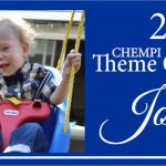A child on a swing in front of the words " 2 0 1 3 chempi theme contest, joshua."