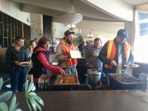 A group of people standing around a table.