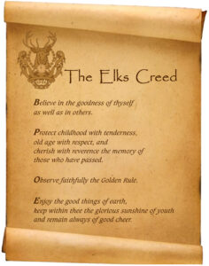 A scroll with the words " the elks creed ".