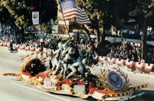 A float with statues of soldiers and an american flag.