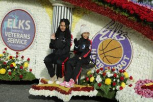 Two girls sitting on a float in the parade.