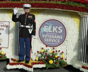A float in the parade with a statue of a marine.