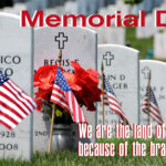 A memorial day message on the side of some graves.