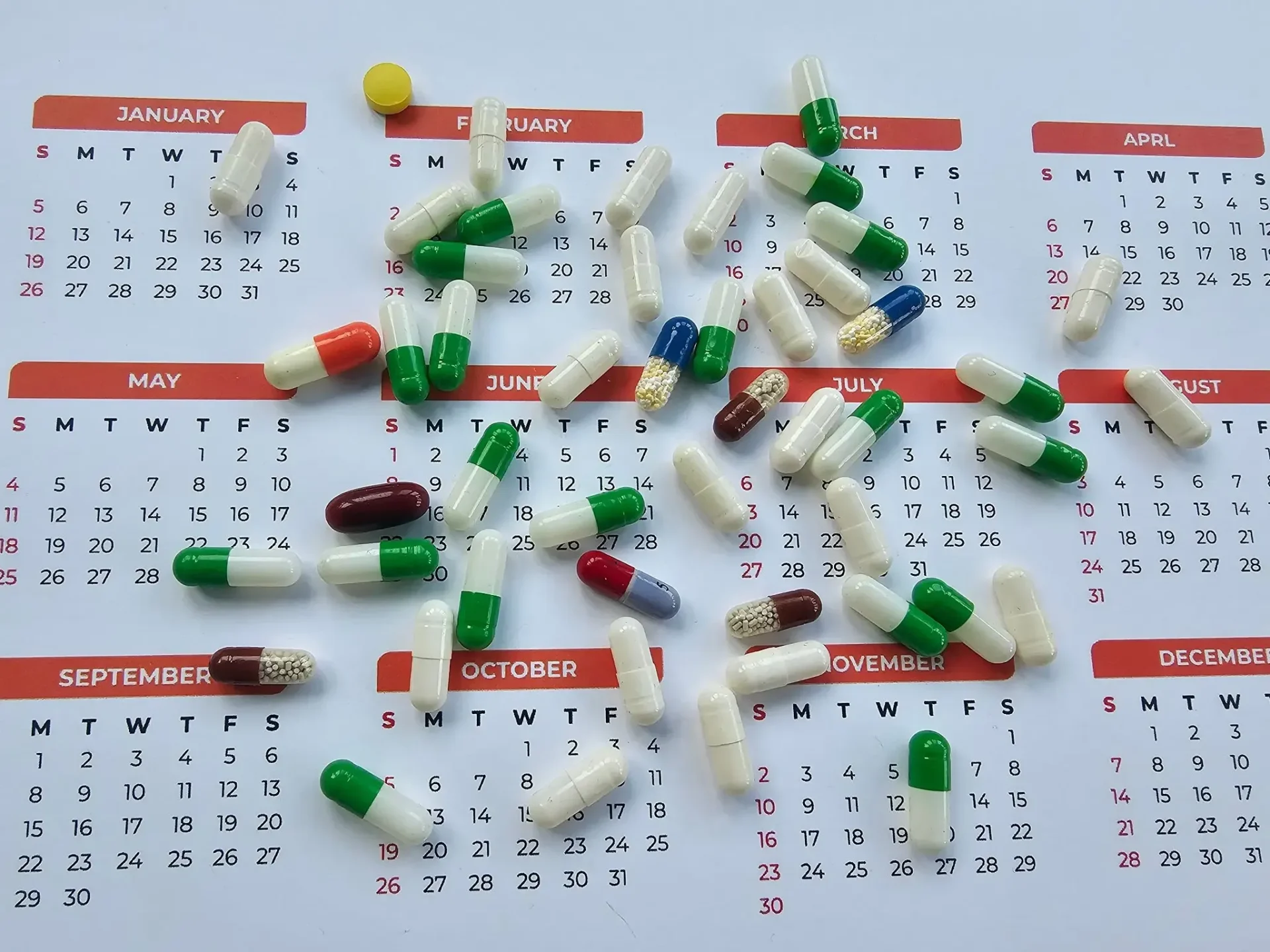 Medication capsules on a calendar