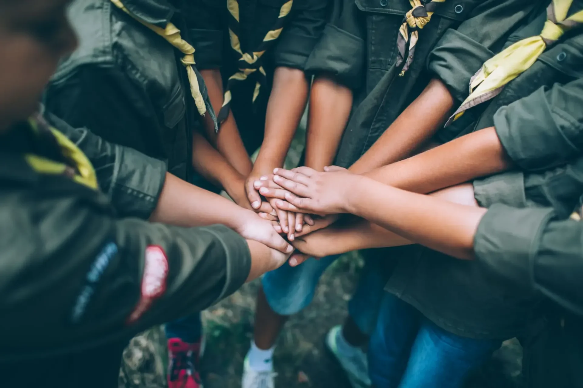 Scouts stacking hands in unity