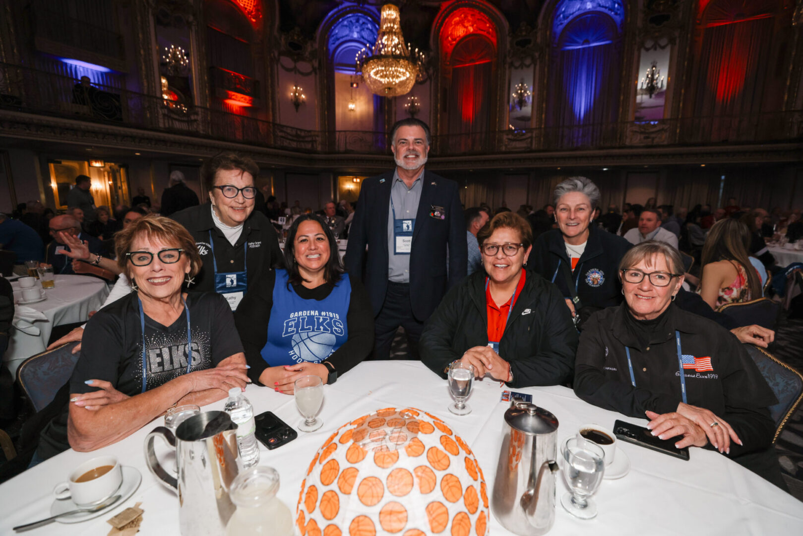 Group of smiling people at ballroom banquet table