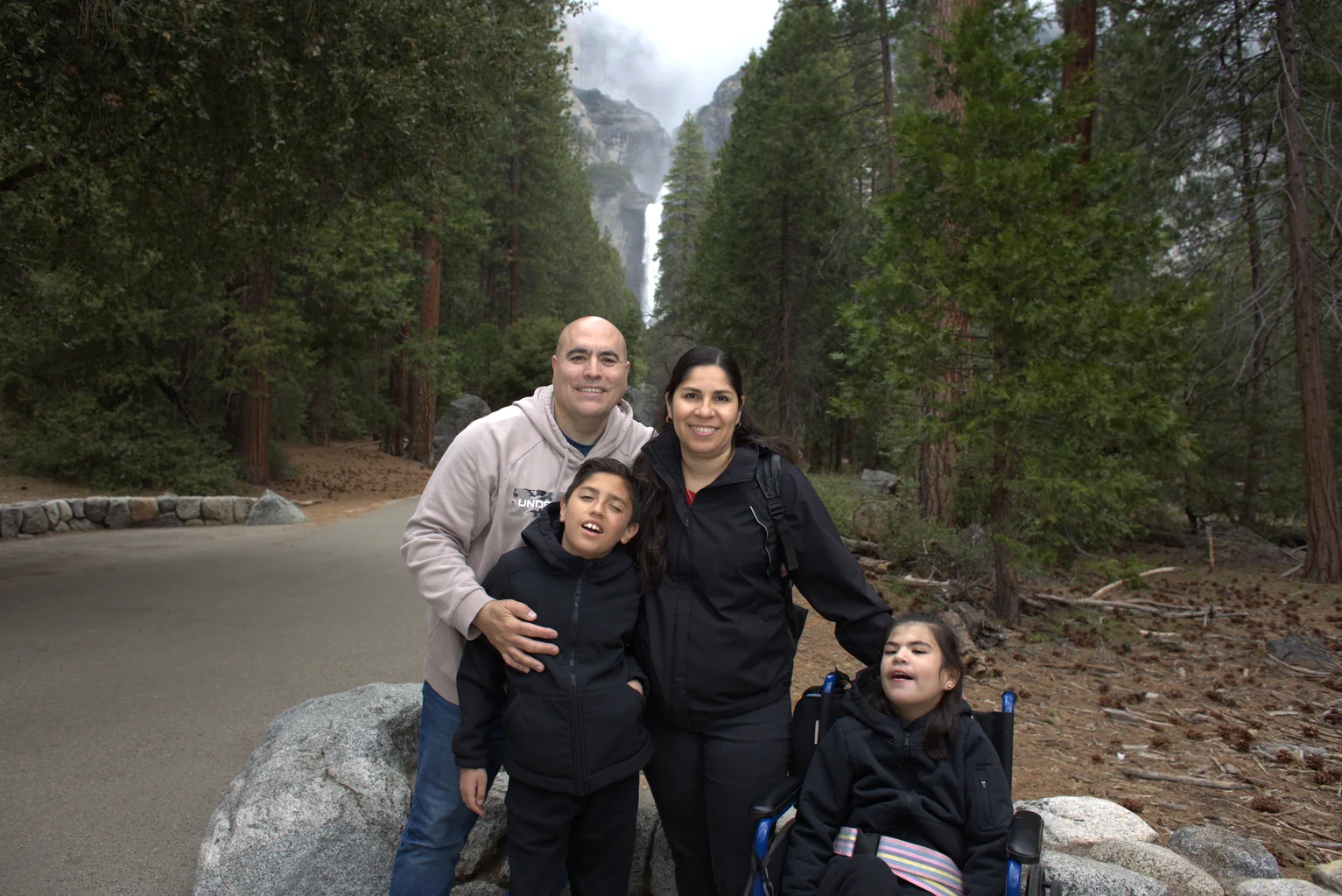 Family with child in wheelchair at waterfall