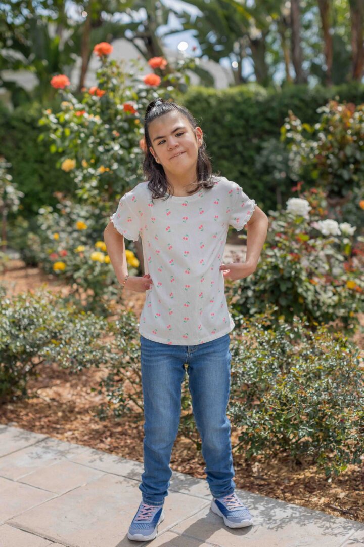Smiling girl standing in flower garden