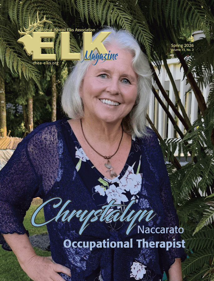 Smiling older woman outdoors by fern plants