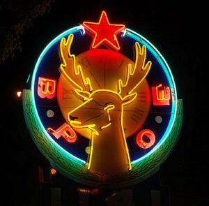 Neon deer head sign with red star