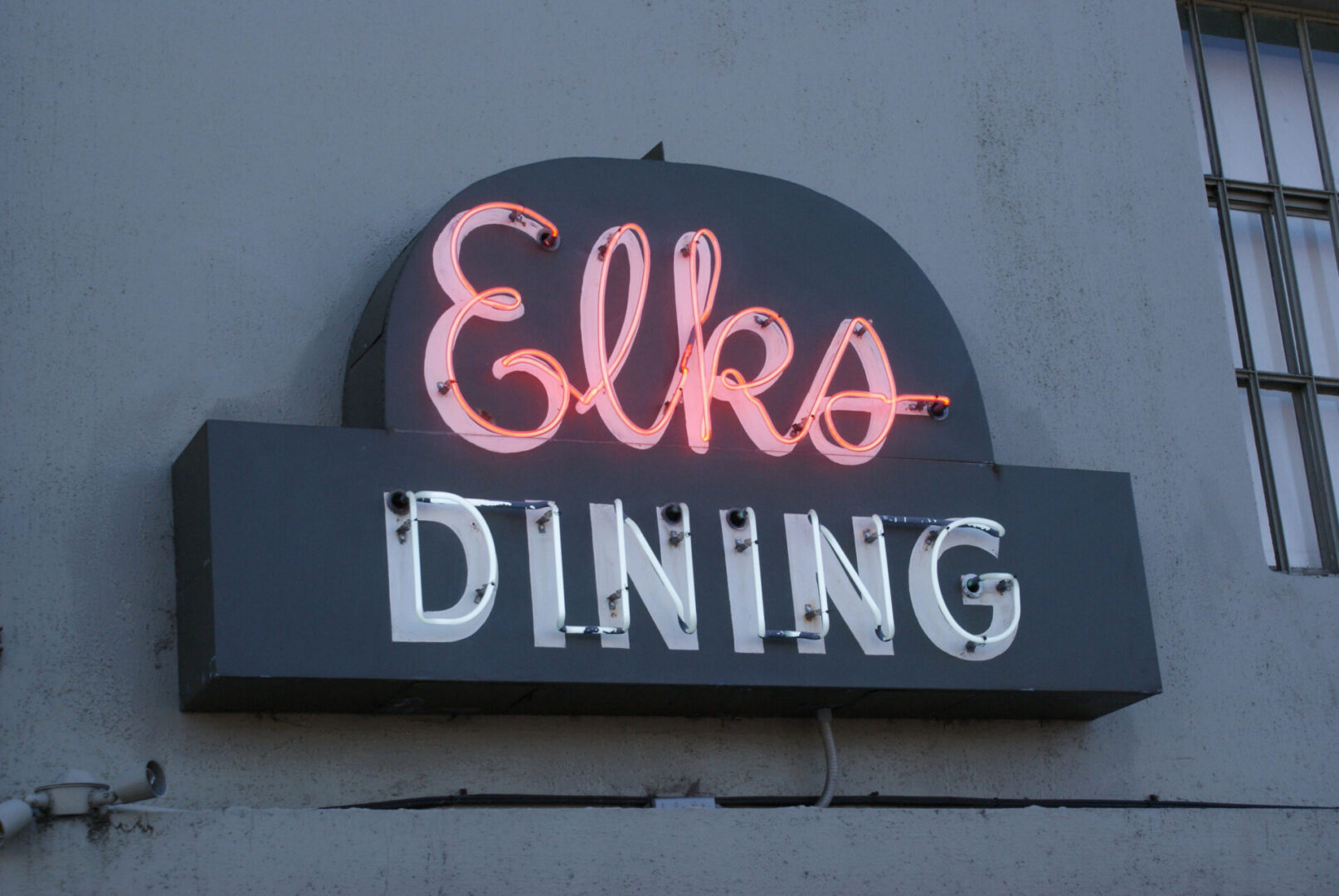 Neon Elks Dining sign on wall