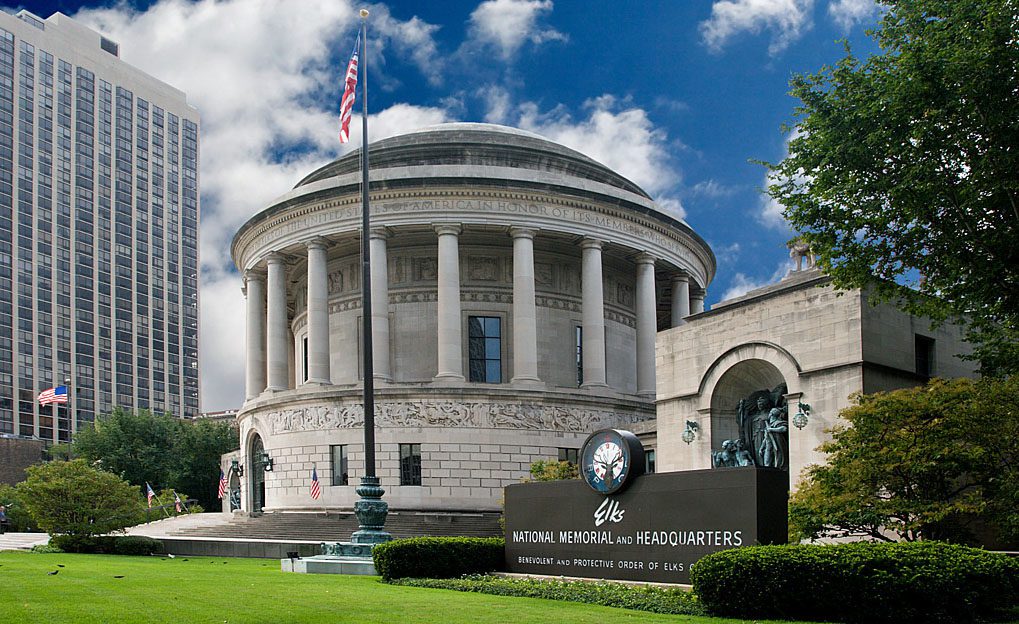 Circular neoclassical memorial with columns and flag