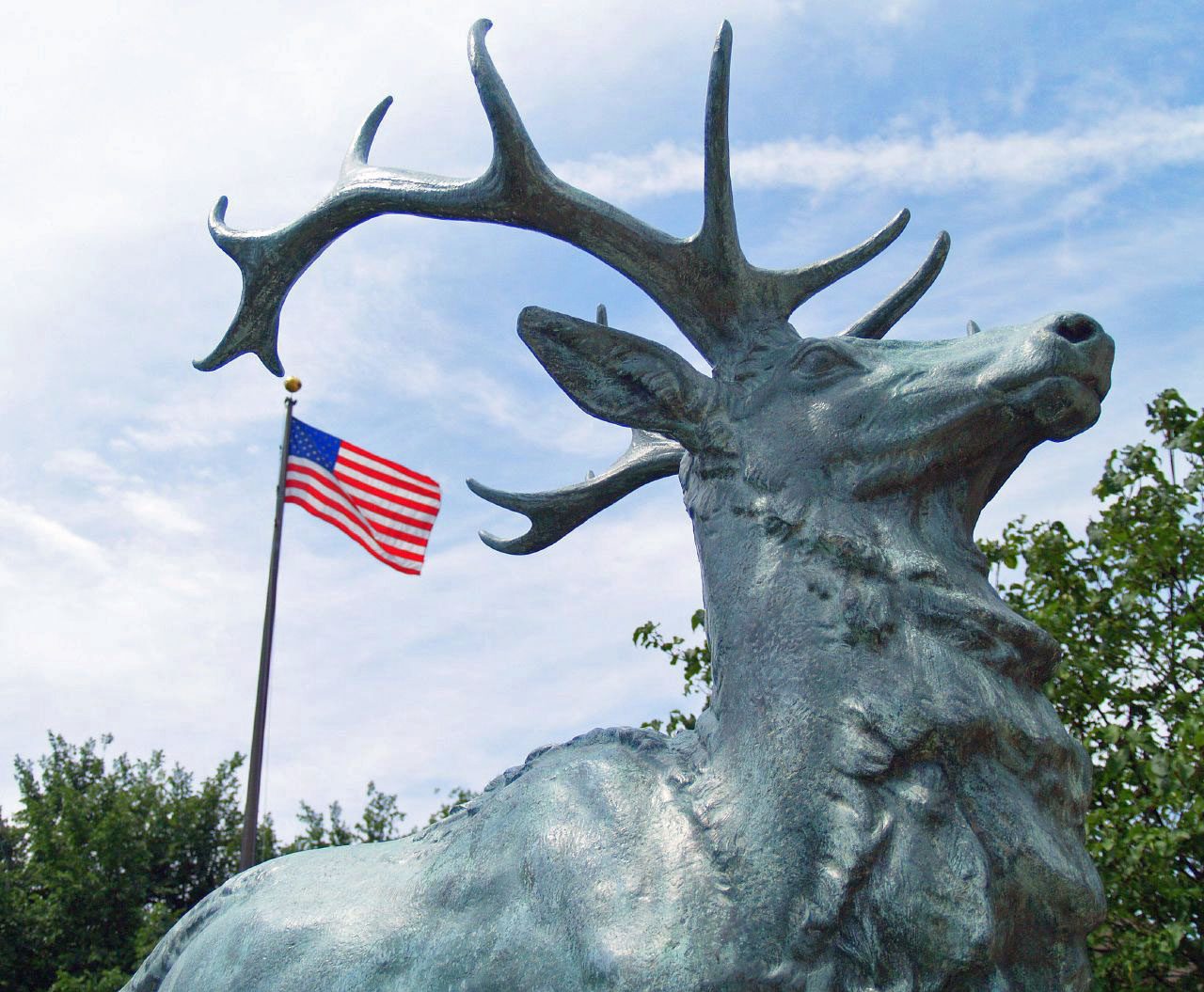 Bronze elk statue with American flag
