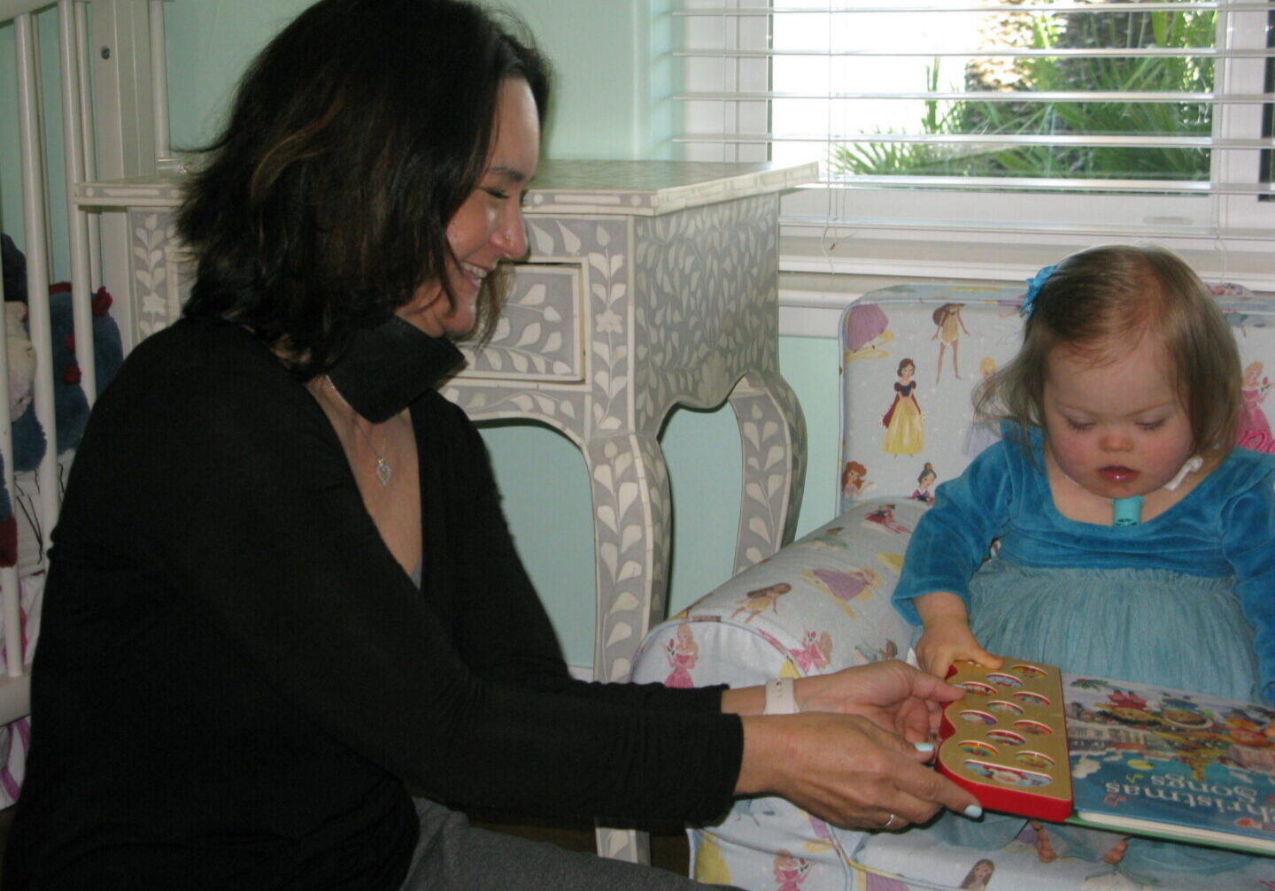 Woman handing book to young girl